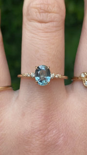 14k gold ring featuring a 1.27ct Montana oval sapphire with diamond side stones—timeless sparkle with an elegant silhouette.