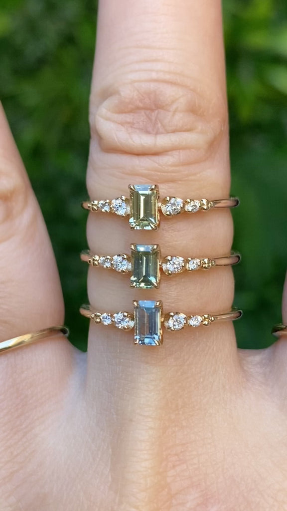 Three Estel Fleur Ring featuring a 0.45ct emerald cut Montana sapphire in 14k yellow gold