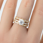 Close-up of a hand wearing a gold Seren Ring with sparkling natural white diamonds and delicate band details