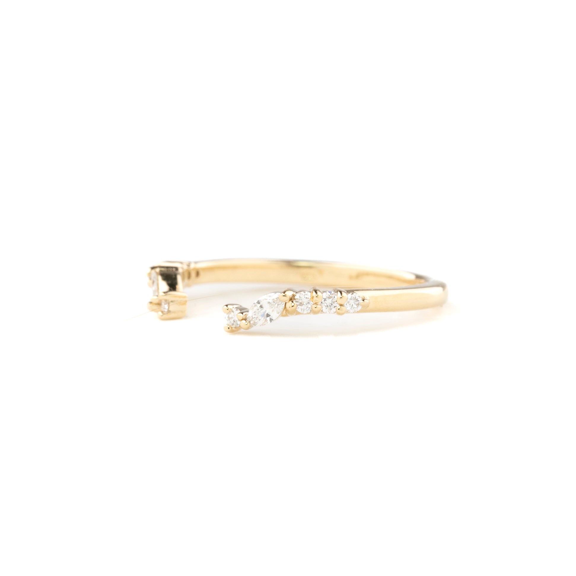 Gold ring with small diamonds on a white background