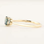 14k yellow gold Nina ring with 0.94ct teal blue Montana sapphire in classic low profile four-prong setting