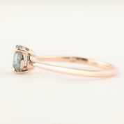 Side view of Nina Ring with 0.98ct light green Montana sapphire set in 14k rose gold tapered band