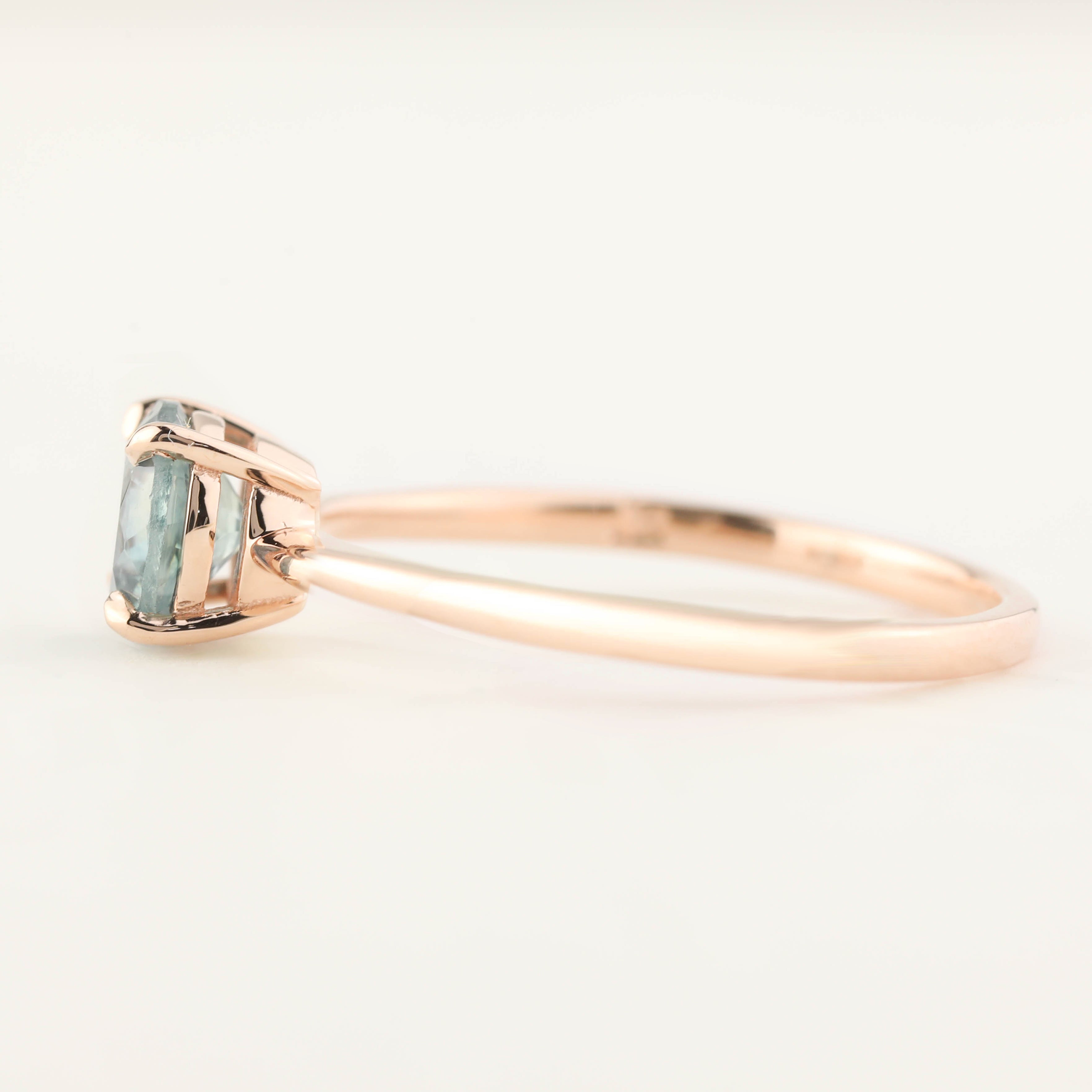 Side view of Nina Ring with 0.98ct light green Montana sapphire set in 14k rose gold tapered band