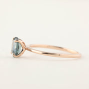 Rose gold ring with a 1.00ct teal blue Montana sapphire in a high profile flower setting, size 7, re-sizable.