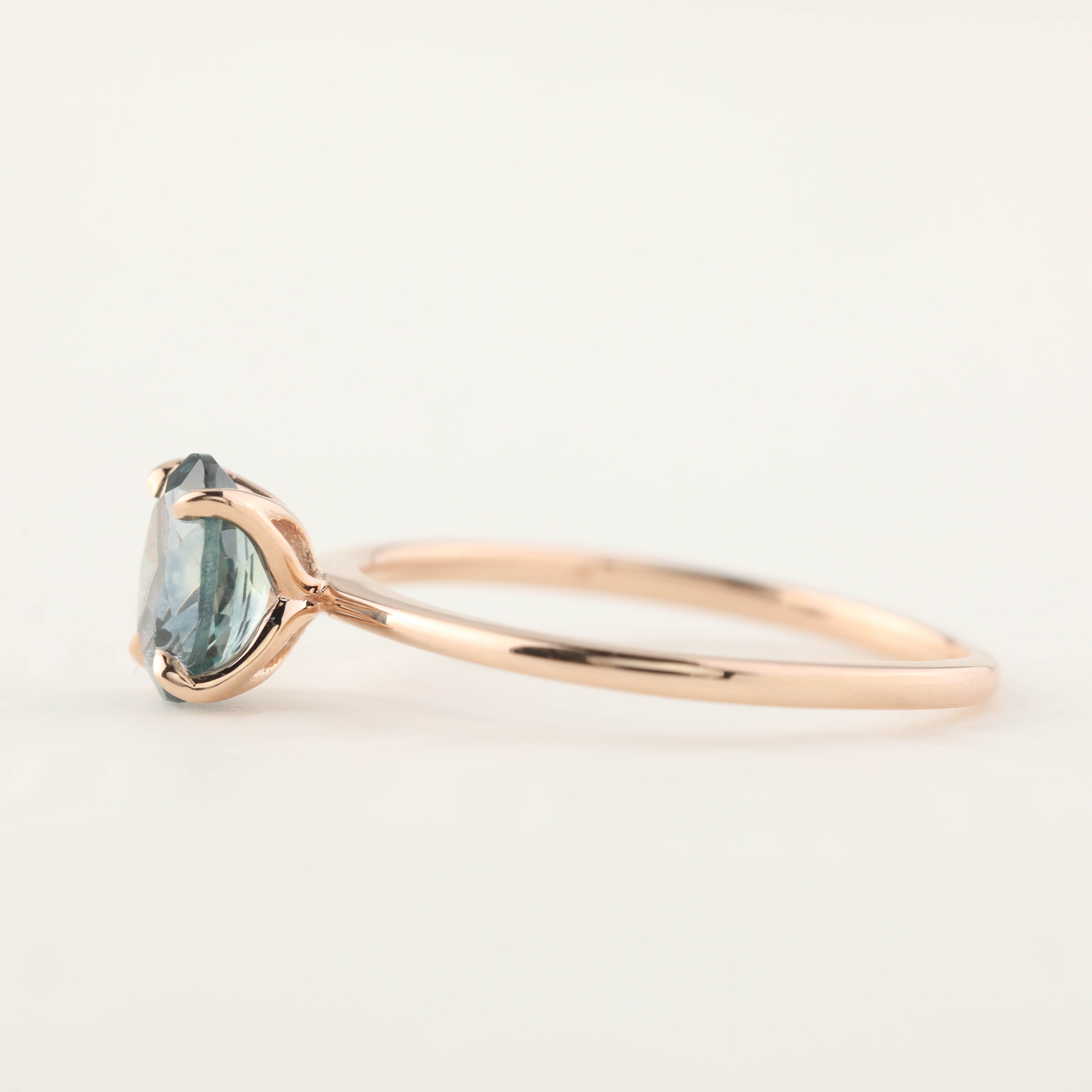 Rose gold ring with a 1.00ct teal blue Montana sapphire in a high profile flower setting, size 7, re-sizable.