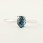 14k white gold ring with 1.00ct oval parti blue green Montana sapphire in a high profile flower setting