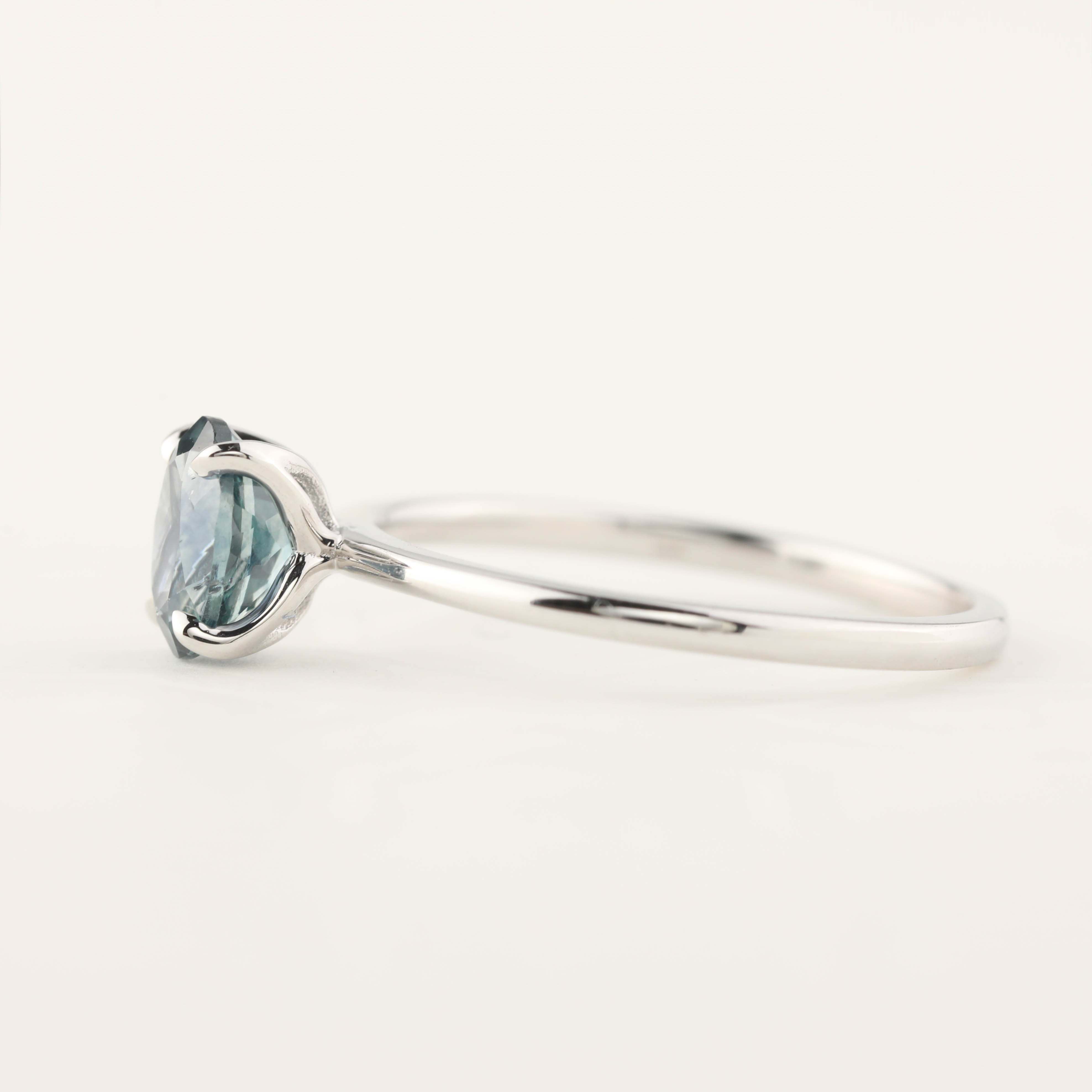 Close-up of a Sara Ring with a 1.00ct blue green Montana sapphire set in 14k white gold band