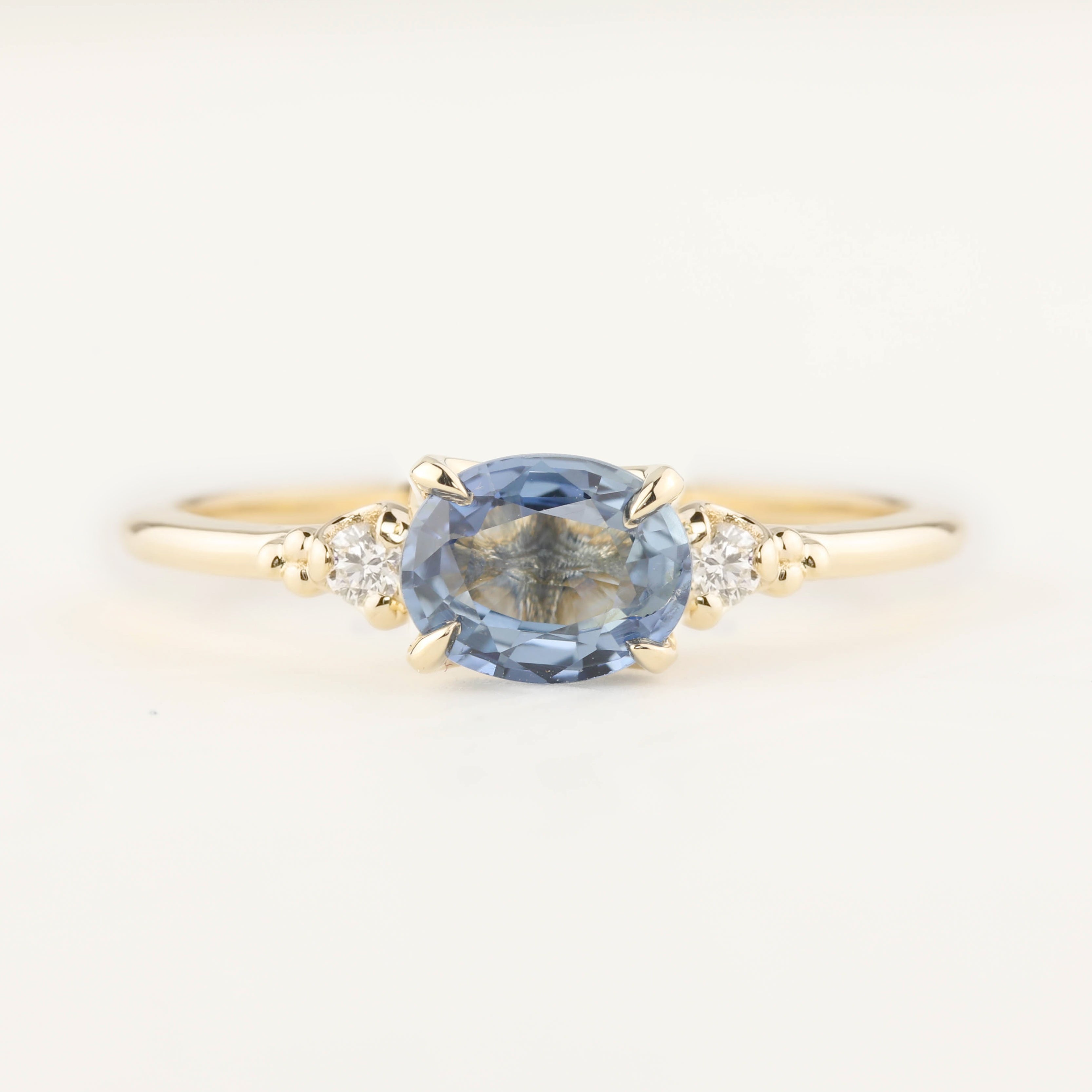 Unique Estel ring with 0.97ct blue sapphire and small white diamonds set in recycled 14k gold band