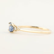 Close-up of Estel Ring featuring 0.97ct blue sapphire and diamond accents in recycled 14k gold four-prong setting