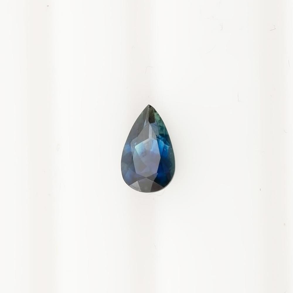 1.06ct pear shaped Montana sapphire in deep navy blue with vibrant inner flashes, 8x4.95x3.42mm gemstone view.