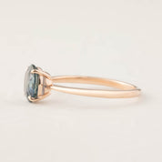 Side view of Nina Ring with 1.24ct teal blue Montana sapphire set in 14k rose gold tapered band