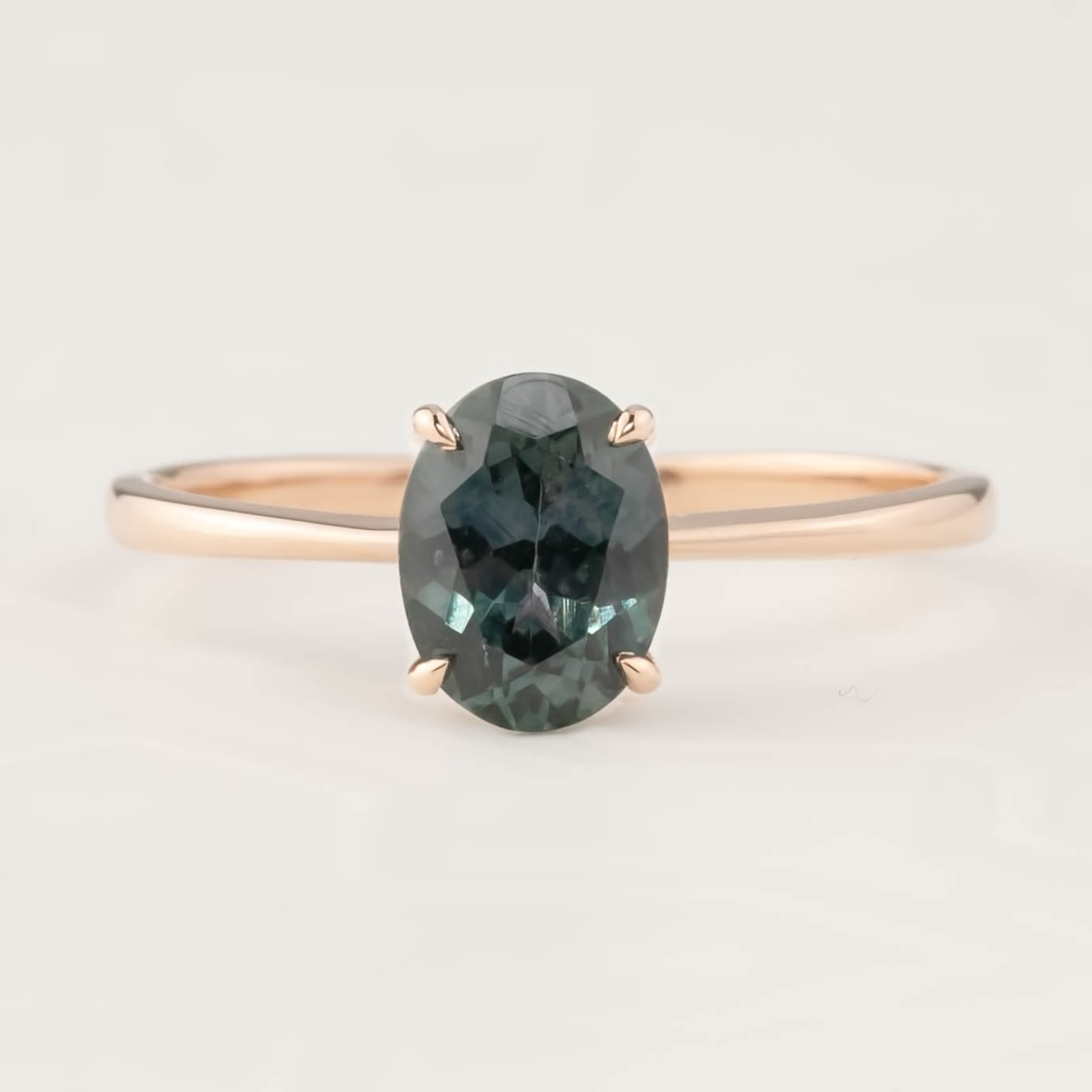 Close-up of Nina Ring with 1.53ct peacock Montana sapphire set in a 14k rose gold tapered band