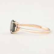 Side view of Nina Ring featuring 1.53ct peacock Montana sapphire set in 14k rose gold with a tapered band