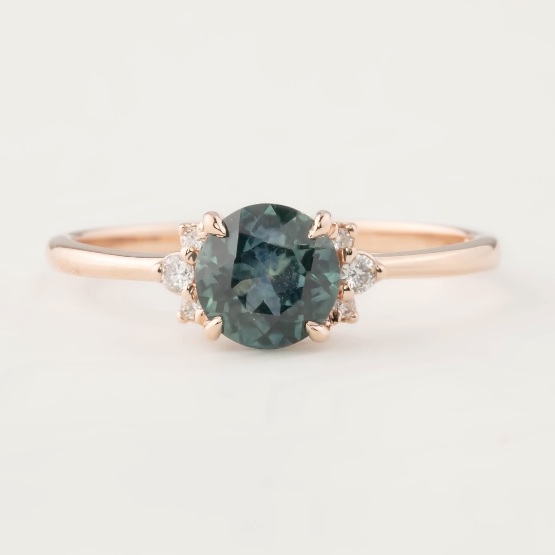 Close-up of Lena Ring with 1.16ct Montana sapphire and small white diamonds set in 14k rose gold band