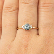 14k gold Lena Ring with 1.14ct Montana sapphire and diamond accents on finger, size 7, low profile setting