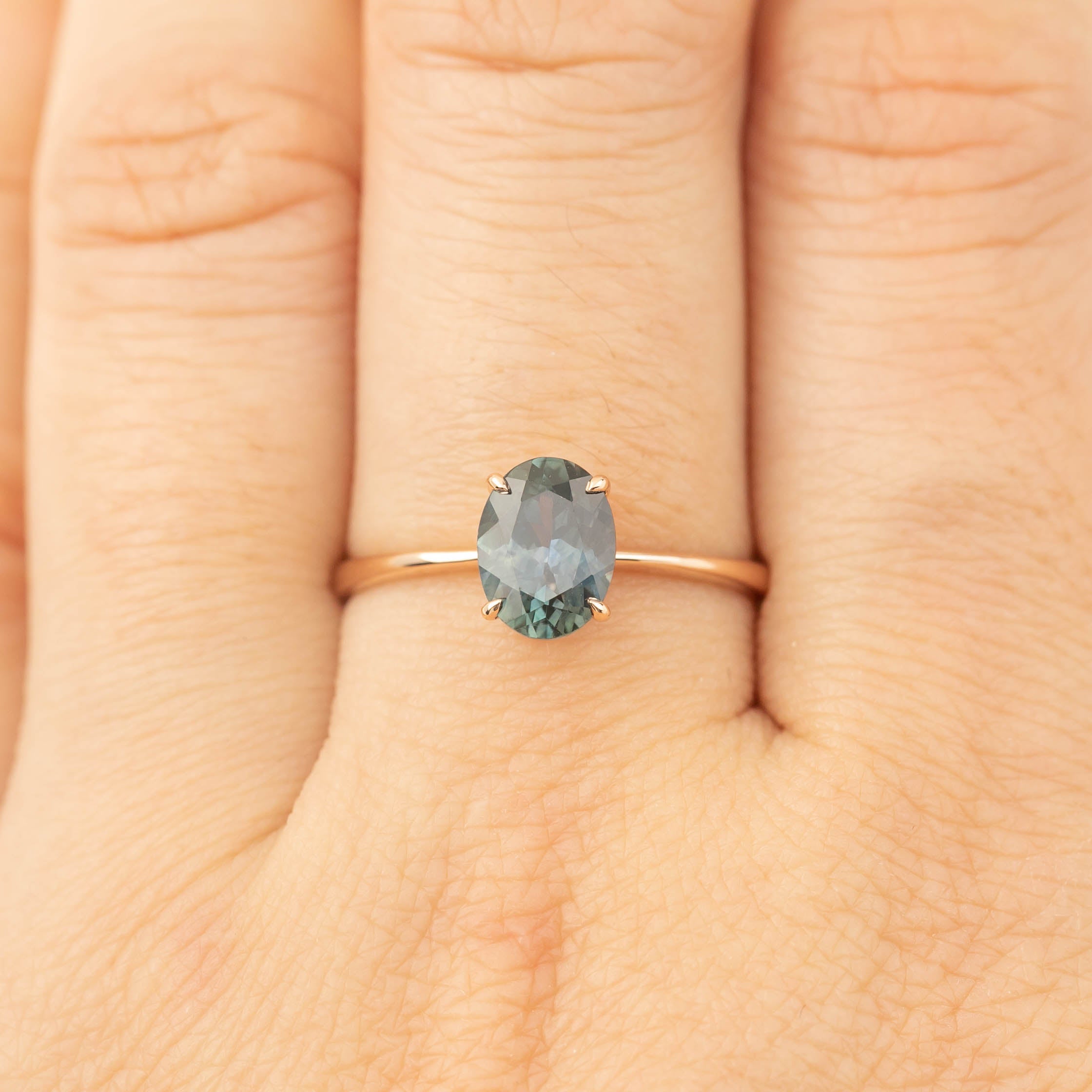Nina Ring featuring 1.53ct oval peacock Montana sapphire in 14k rose gold with a delicate tapered band.