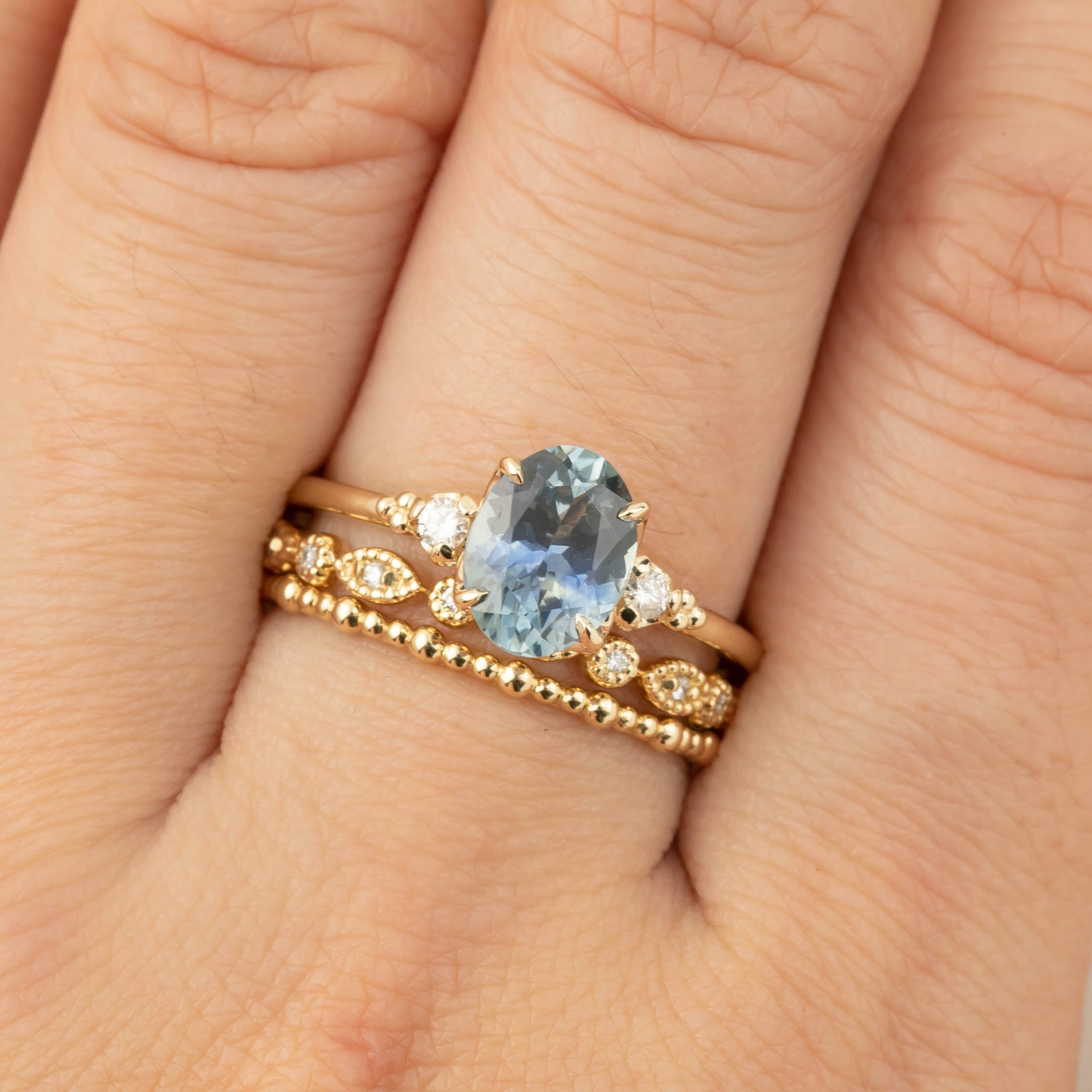 Close-up of Estel Ring featuring 1.62ct teal Montana sapphire with diamond accents on recycled 14k gold band