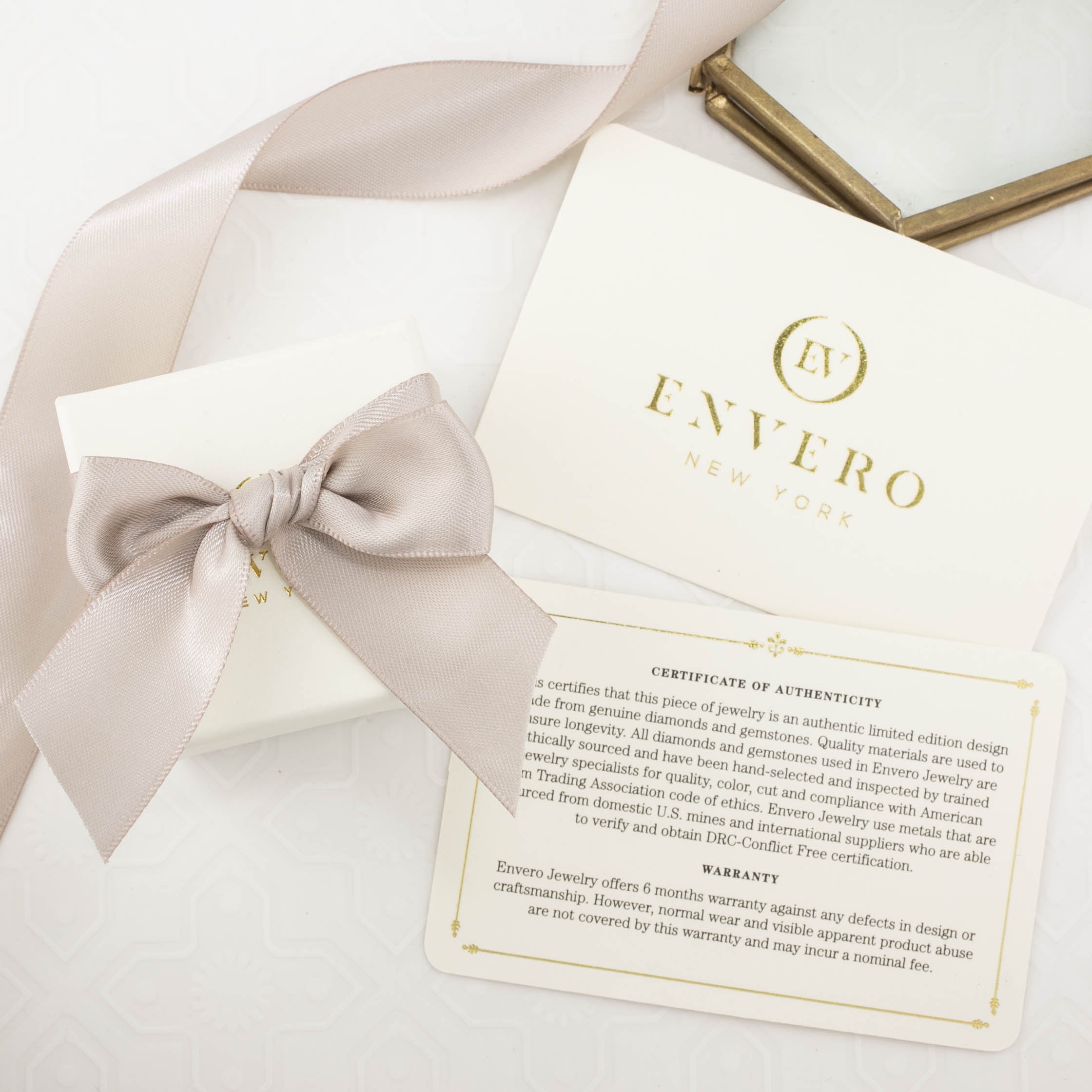 Recyclable kraft ivory ring box with satin bow and Envero New York authenticity certificate inside.