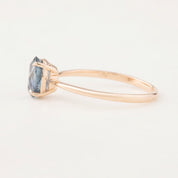 Side view of Nina Ring with 1.4ct blue Montana sapphire in 14k rose gold four-prong setting, size 7 resizable 3-8.5