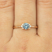 Delicate 14k rose gold ring with 0.72ct blue Montana sapphire and small brilliant cut diamonds on finger size 7.