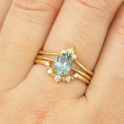 Close-up of Nina Ring with 1.4ct light blue Montana sapphire and accent diamonds set in recycled 14k yellow gold band