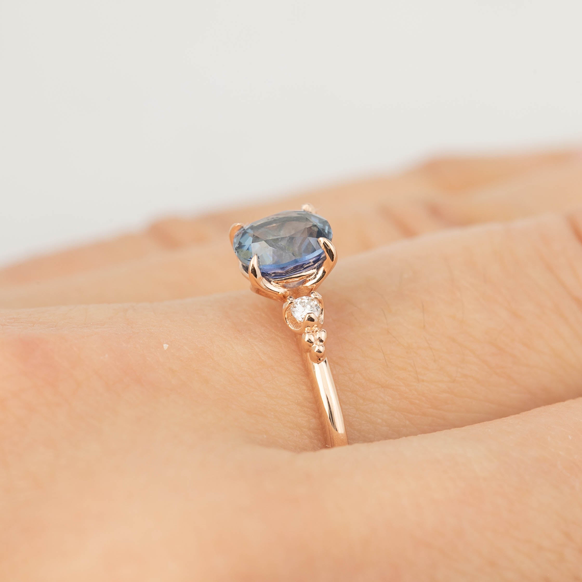 14k rose gold Estel ring with 1.24ct blue sapphire and diamond accents on hand, size 7, adjustable 4-8.5