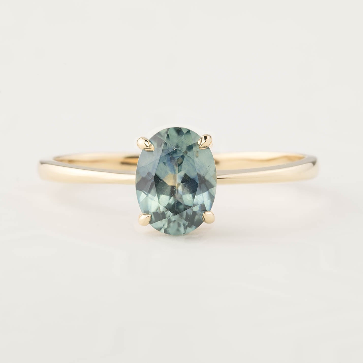 14k yellow gold ring featuring a 1.26ct oval Montana sapphire in four prong setting, size 7, resizable 3-8.5
