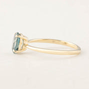Side view of Nina Ring featuring 1.26ct Montana sapphire in 14k yellow gold four-prong basket setting