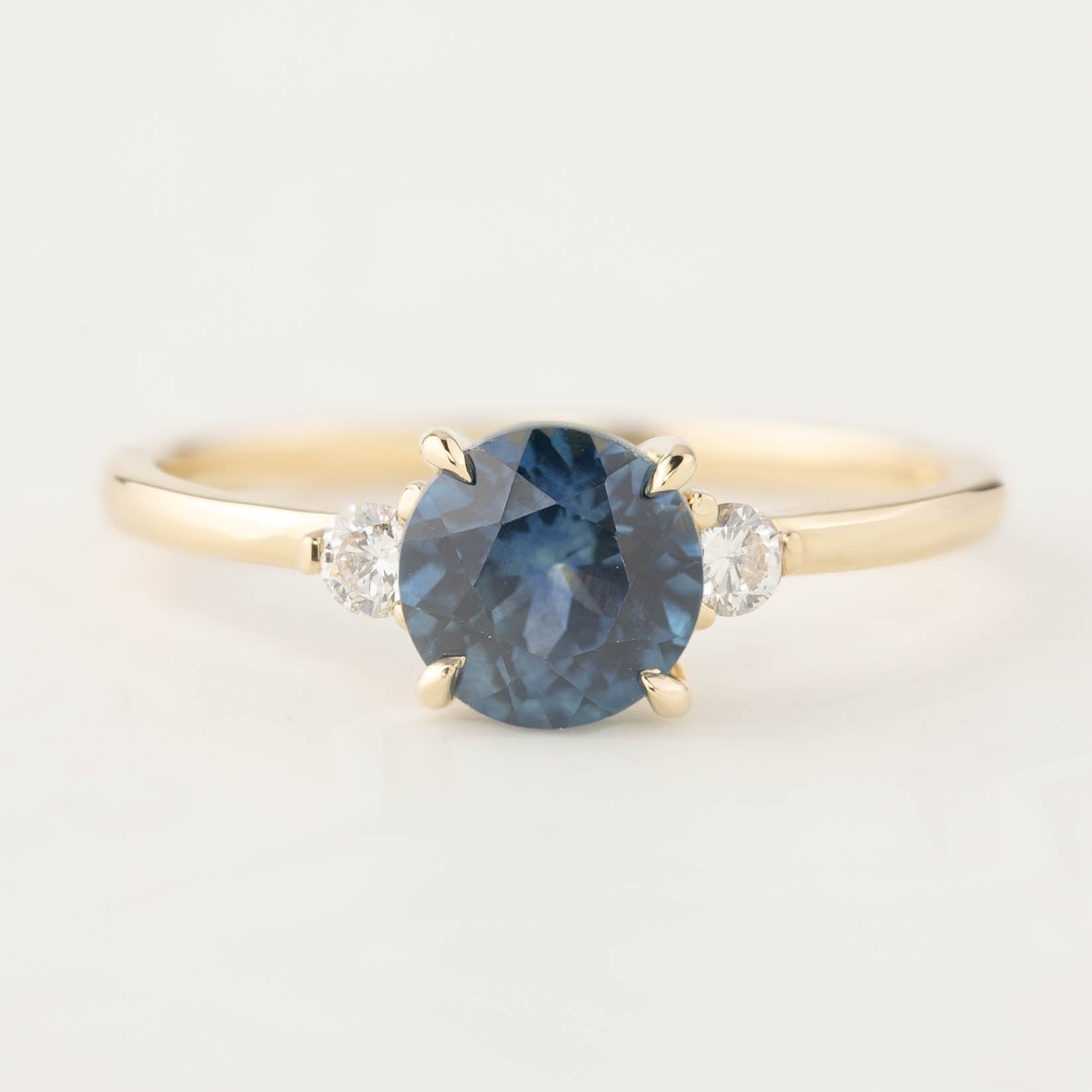 Elegant Emilie ring featuring 1.46ct round Montana sapphire with diamond accents in 14k gold band