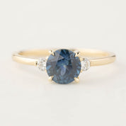 Elegant Emilie ring featuring 1.46ct round Montana sapphire with diamond accents in 14k gold band