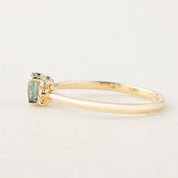 Side view of Lena ring featuring 0.66ct teal Montana sapphire set in recycled 14k gold band