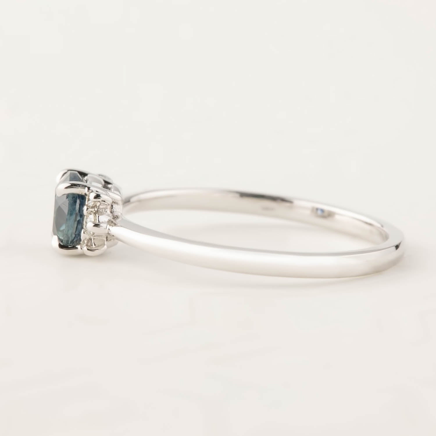 Side view of the Lena Ring featuring a 0.65ct blue Montana Sapphire set in recycled 14k white gold band