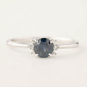 Close-up of Lena Ring with 0.65ct blue Montana sapphire and small diamonds set in 14k white gold band