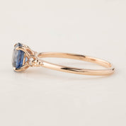 Side view of Estel Ring featuring 1.18ct blue sapphire and 14k rose gold band with diamond accents