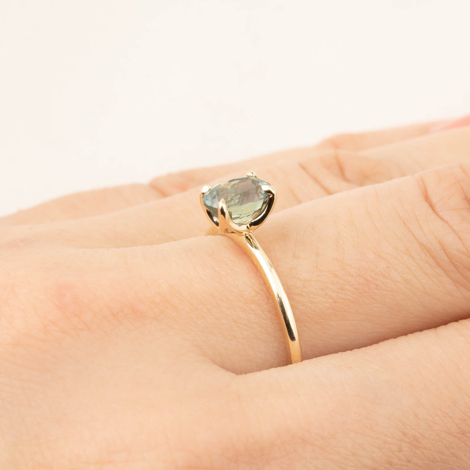 Sara Ring with 1.36ct green peacock sapphire set in 14k recycled yellow gold, size 7, elegant flower setting.
