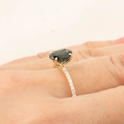 Close-up of a Maria Ring with 1.64ct green tourmaline and diamond pave band in 14k yellow gold on hand.