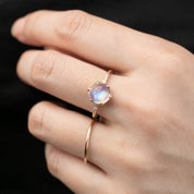 14k gold Grace Ring with 1.8ct cabochon rainbow moonstone and white accent diamonds on hand model