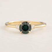 14k yellow gold ring featuring a 0.85ct Queensland peacock sapphire with two white accent diamonds in a four-prong setting