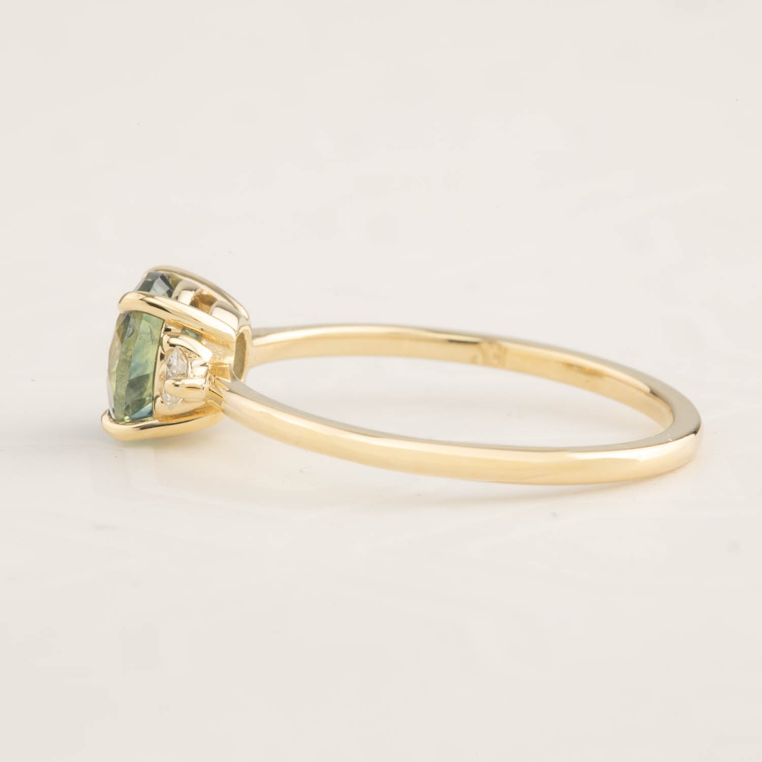 Side view of Emilie Ring with 1.31ct blue-green Montana sapphire set in recycled 14k gold band
