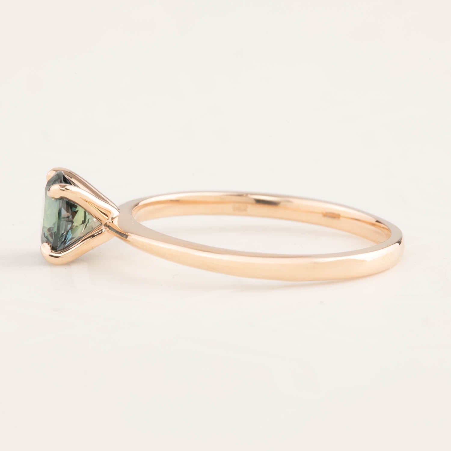 Side view of Jane Ring featuring 0.96ct blue-green Queensland sapphire in 14k rose gold tapered band