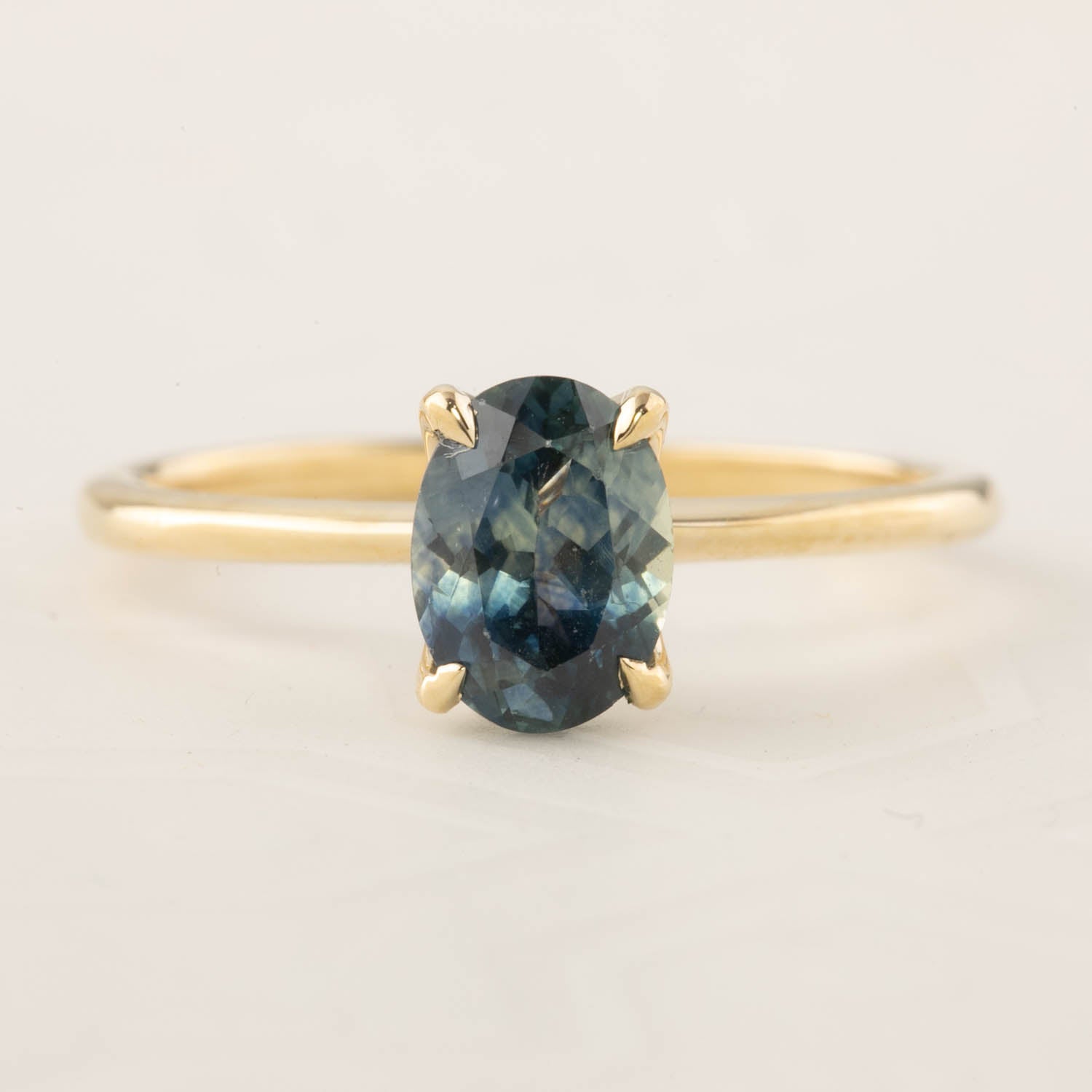 Sara Ring featuring 1.32ct blue Montana sapphire set in 14k yellow gold with a delicate straight band design