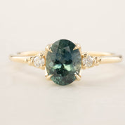 Light blue-green 1.78ct Montana sapphire ring with white diamond accents in recycled 14k yellow gold band