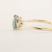 Side view of Nina Ring with 1.4ct light blue Montana Sapphire in 14k yellow gold tapered band
