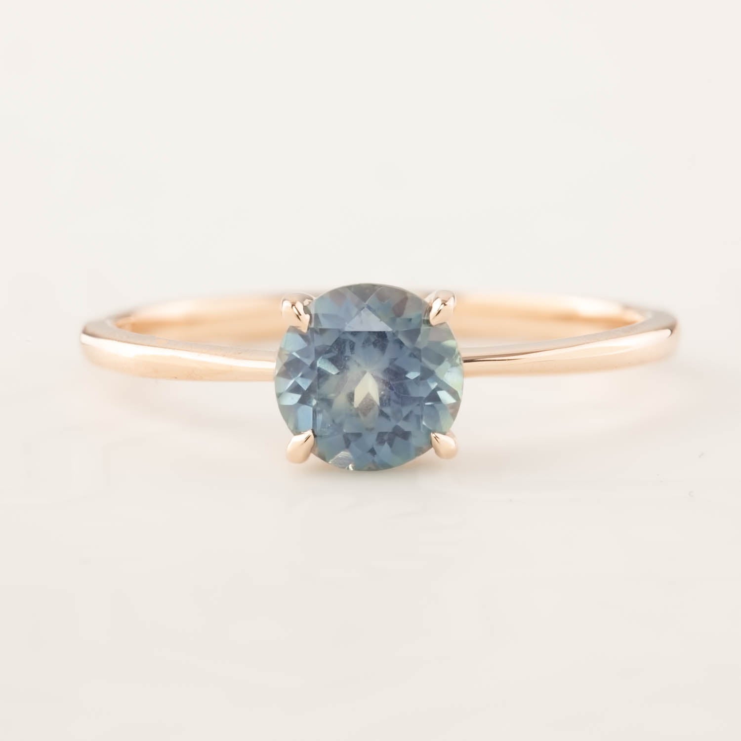 Nina Ring featuring a 1.12ct parti blue Montana sapphire set in 14k rose gold, handmade and ethically sourced by Envero Jewelry.