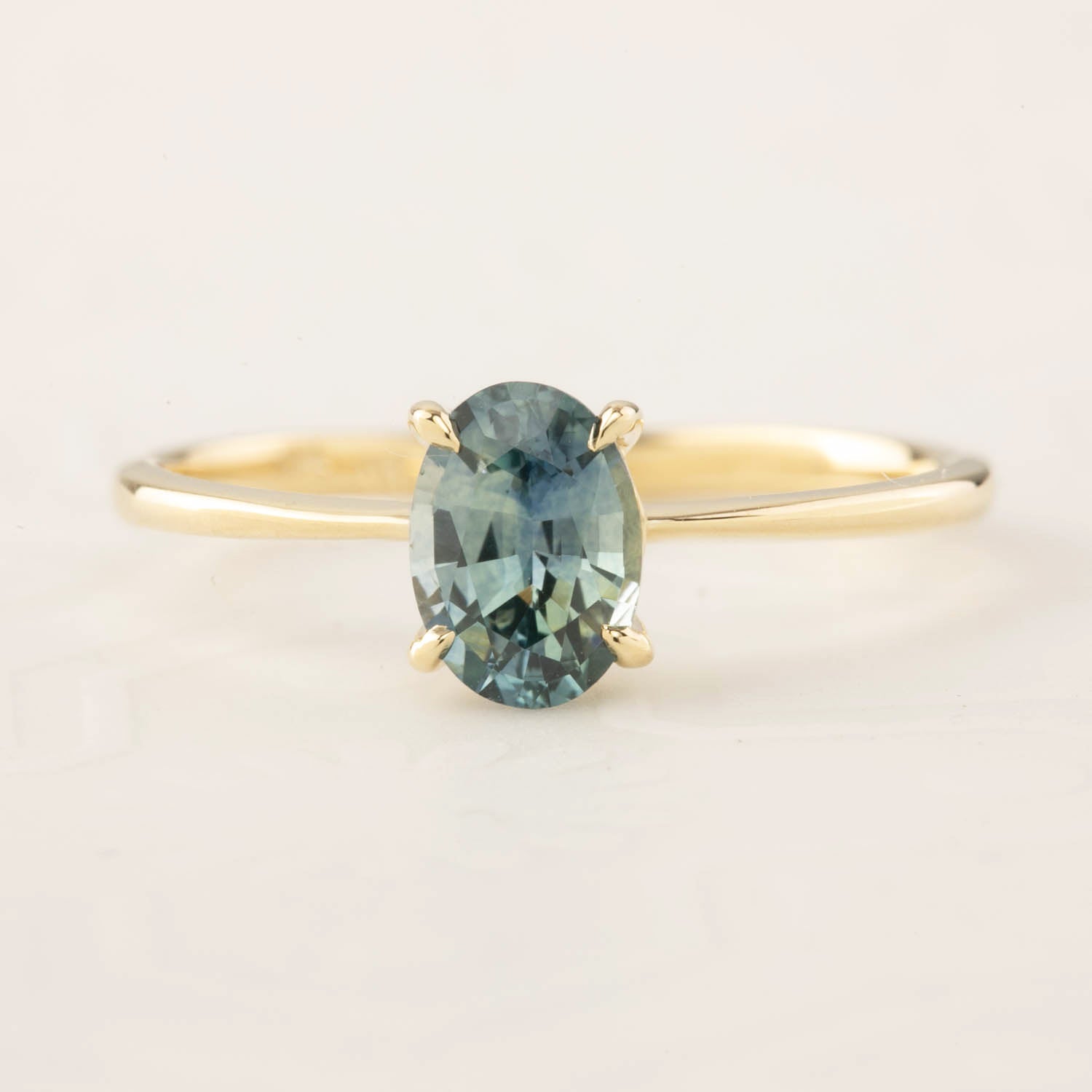 Close-up of a one-of-a-kind Nina Ring with 0.98ct green Montana sapphire set in 14k yellow gold band