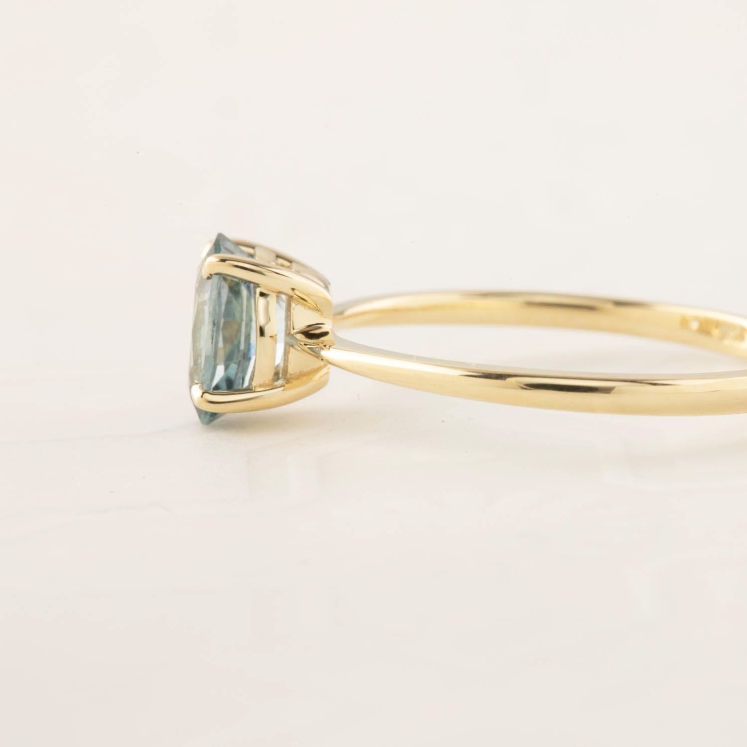 Side view of Nina Ring with 0.98ct green Montana sapphire set in 14k yellow gold tapered band