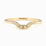 Curved solid gold ring with natural white diamonds set in a U-shaped band, ethically sourced and elegant design