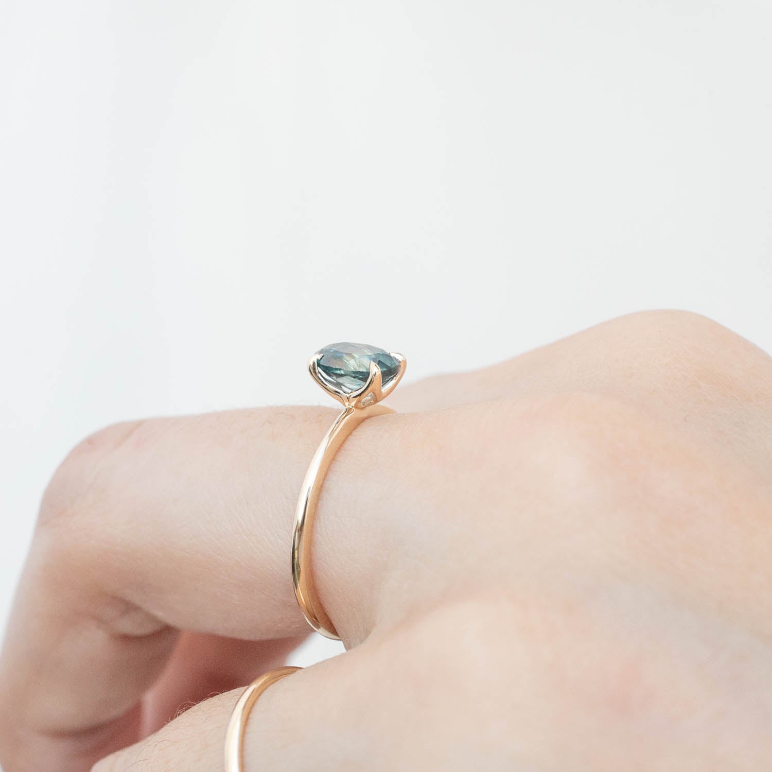 Sara Ring with 1.32ct blue Montana sapphire set in 14k yellow gold with signature flower setting on finger