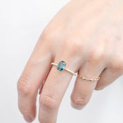 Hand wearing Maria Ring with 1.53ct unheated oval green Queensland sapphire set in 14k yellow gold band