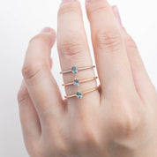 Alice Ring, 0.20ct Unheated Sapphire ring in 14k yellow gold, rose gold and white gold on a finger.
